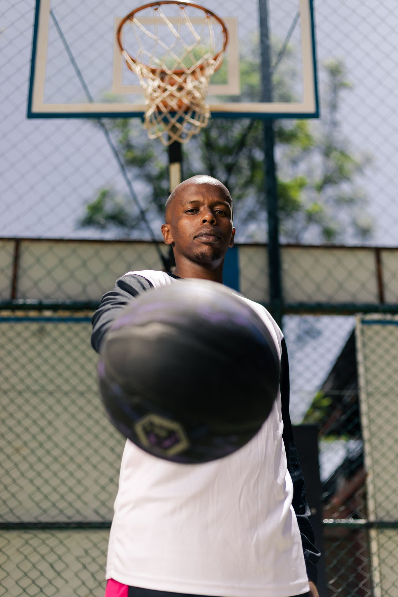 Jasiri athlete extending a basketball toward the camera