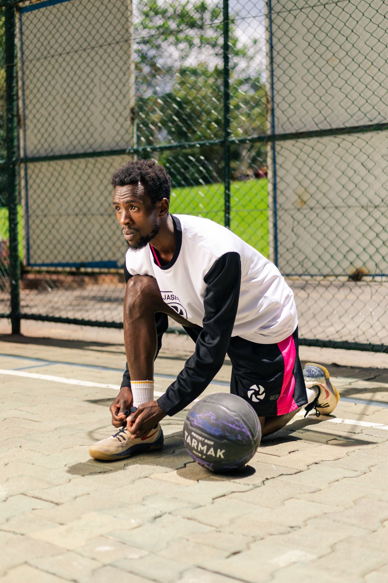 Athlete lacing up courtside